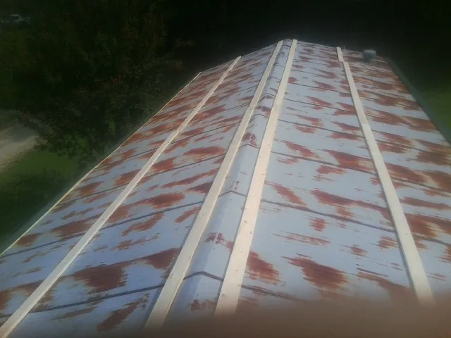 Rusted metal roof panels with new wood purlins before replacement — Storm Damage Roof Repair in Columbus by Roofing Brothers
